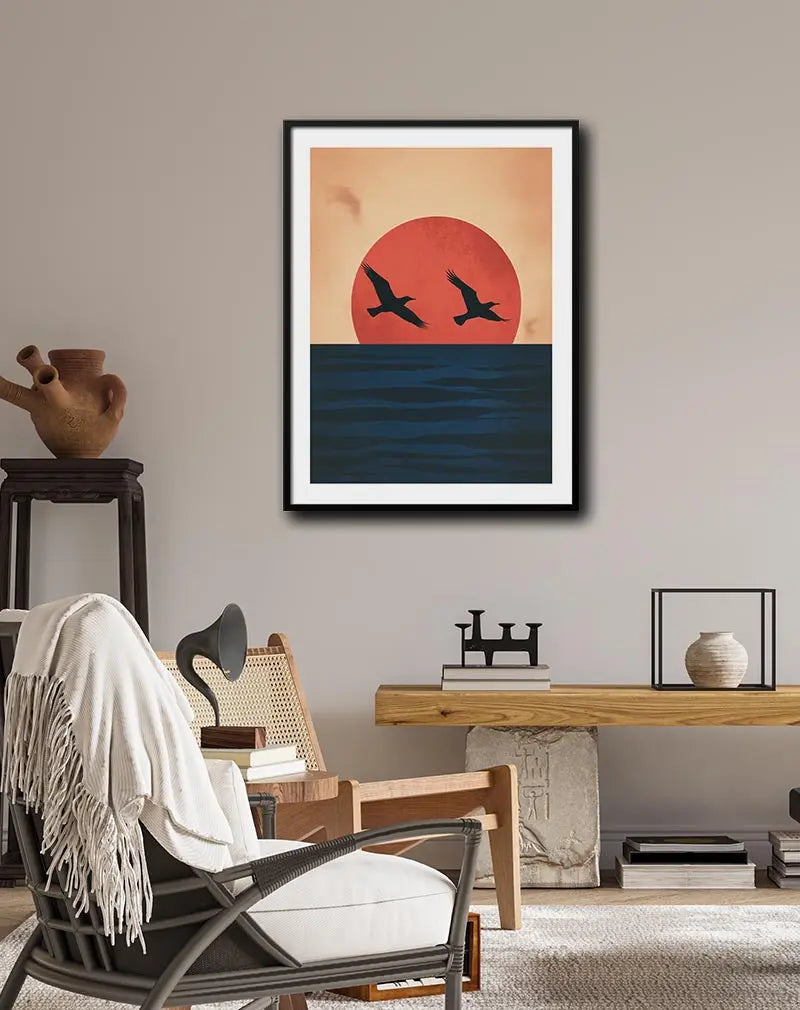 A serene illustration of two birds flying over the ocean with a large red sun setting in the background. Perfect wall art for creating a calm and peaceful atmosphere, ideal for coastal or nature-inspired decor